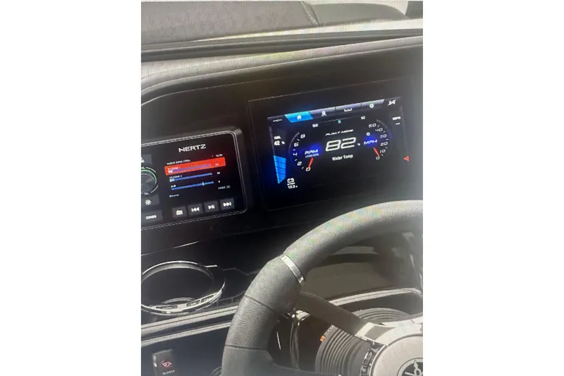 Slide: The Image of Dashboard of 2026 Yamaha Boats 195S featuring digital displays and steering wheel. - 8