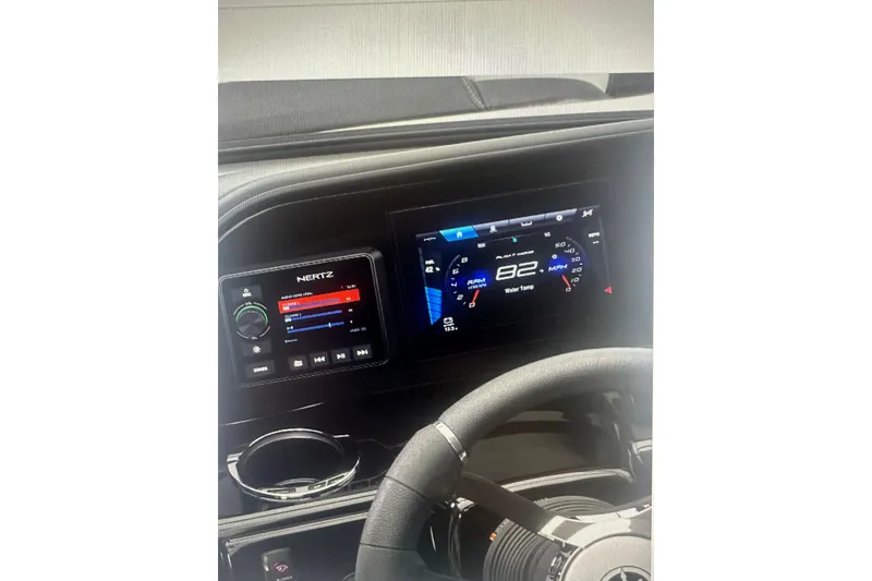 Slide: The Image of Dashboard of 2026 Yamaha Boats 195S, featuring digital displays and steering wheel. - 9