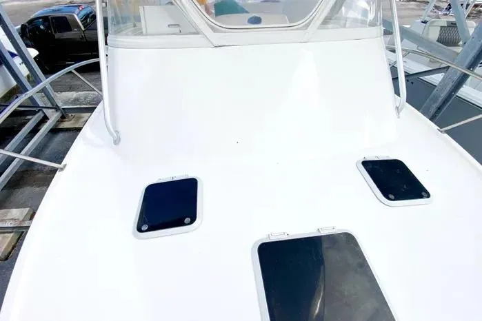 Slide: The Image of 2001 Pursuit 3000 Offshore boat deck with hatches and windshield. - 10