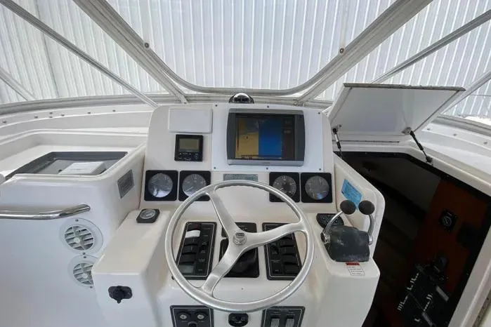 Slide: The Image of Helm of 2001 Pursuit 3000 Offshore boat with steering wheel and navigation instruments. - 20