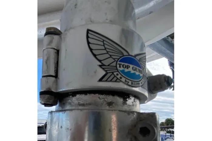 Slide: The Image of Close-up of a 2001 Pursuit 3000 Offshore boat part with "Top Gun" logo. - 22