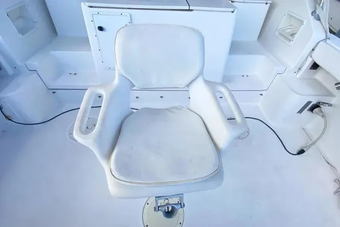 Slide: The Image of White captain's chair on 2001 Pursuit 3000 Offshore boat deck. - 24