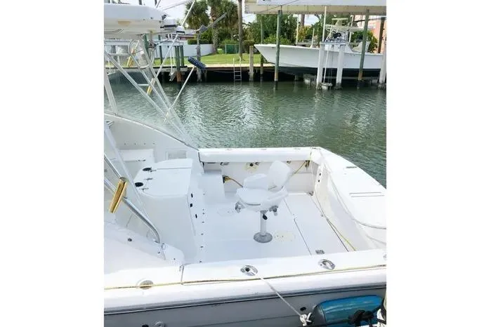 Slide: The Image of 2001 Pursuit 3000 Offshore boat with spacious deck and fishing chair. - 4