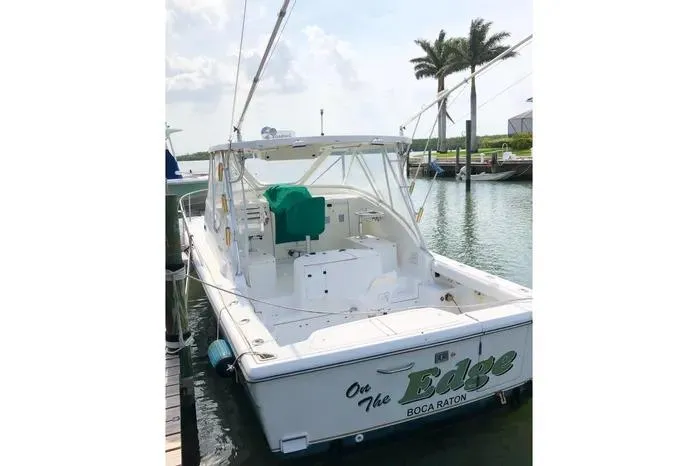 Slide: The Image of 2001 Pursuit 3000 Offshore boat docked, featuring "On The Edge" name, Boca Raton location. - 5