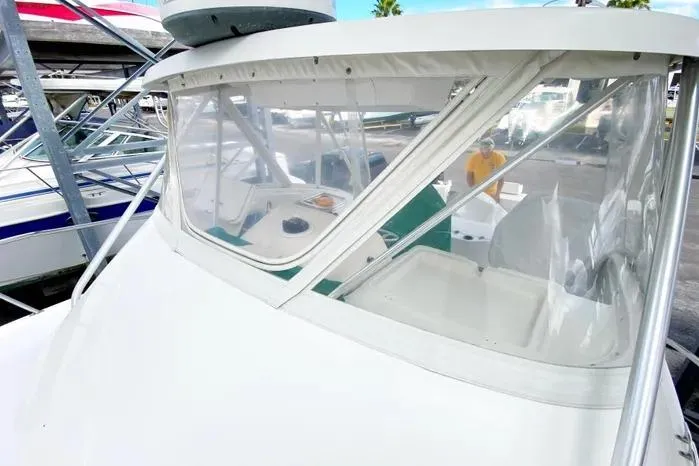 Slide: The Image of 2001 Pursuit 3000 Offshore boat with clear windshield and visible cockpit area. - 7