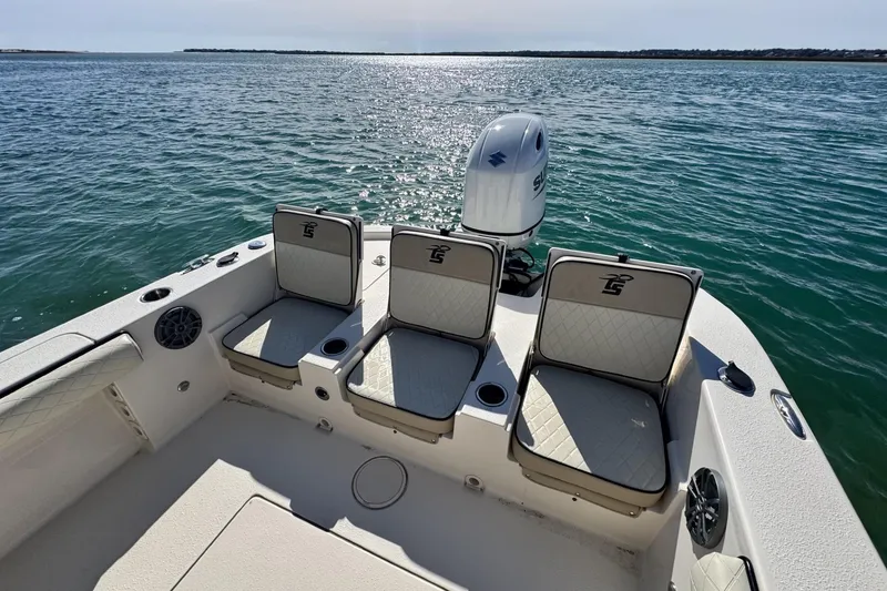 Slide: The Image of 2022 Carolina Skiff 24 Ultra Elite boat with seating, on calm water. - 15