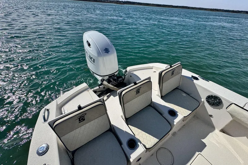 Slide: The Image of 2022 Carolina Skiff 24 Ultra Elite boat with Suzuki outboard motor on calm water. - 17
