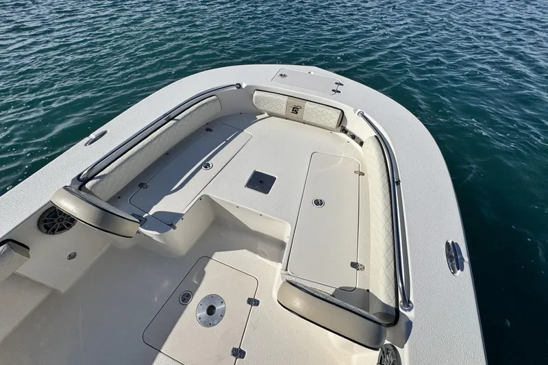 Slide: The Image of 2022 Carolina Skiff 24 Ultra Elite boat deck with seating, on calm water. - 34