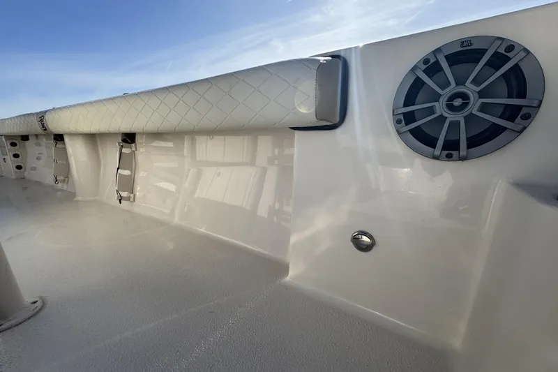 Slide: The Image of 2022 Carolina Skiff 24 Ultra Elite boat interior with speaker and cushioned rail. - 37