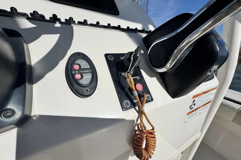 Slide: The Image of Control panel of a 2022 Carolina Skiff 24 Ultra Elite boat with throttle and emergency stop. - 5