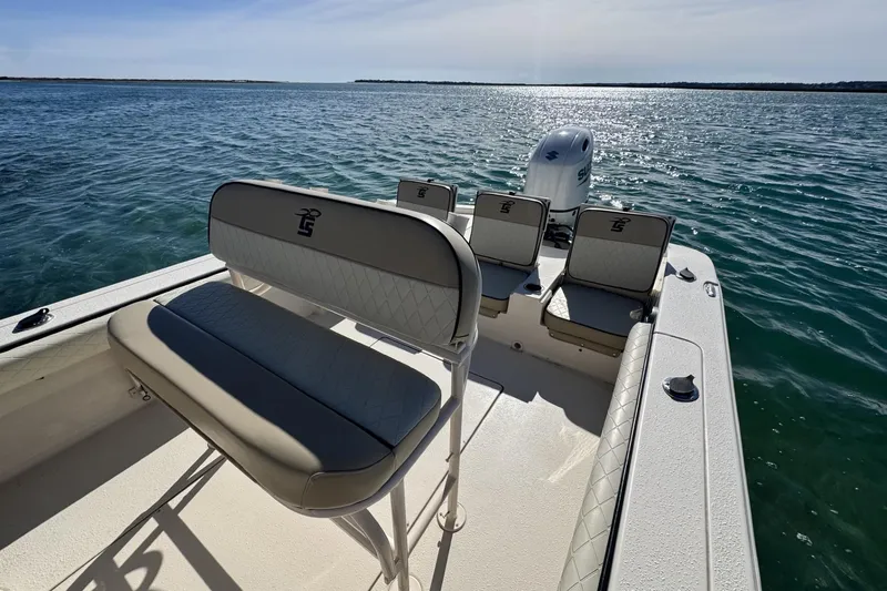 Slide: The Image of 2022 Carolina Skiff 24 Ultra Elite boat on open water, featuring comfortable seating and sleek design. - 8