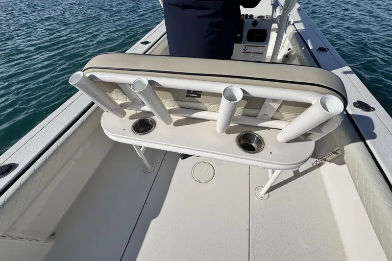 Slide: The Image of 2022 Carolina Skiff 24 Ultra Elite boat interior with rod holders and seating. - 9