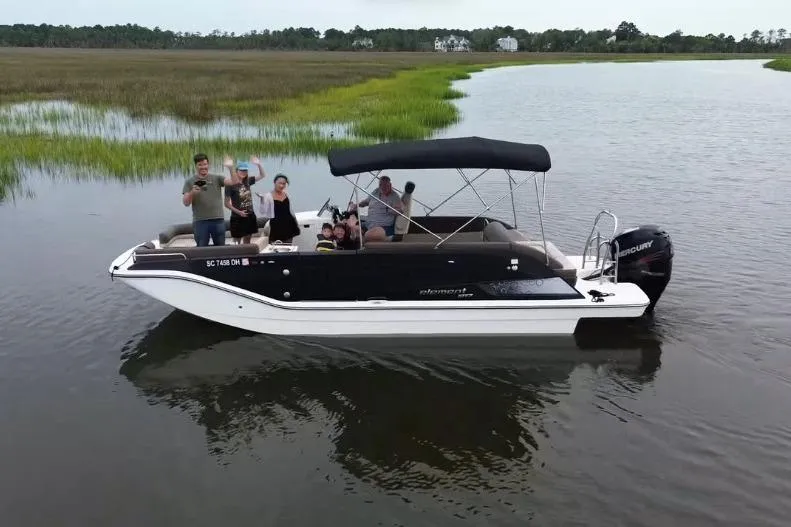 The Image of 2017 Bayliner Element XR7 boat with passengers on a calm river. - 0