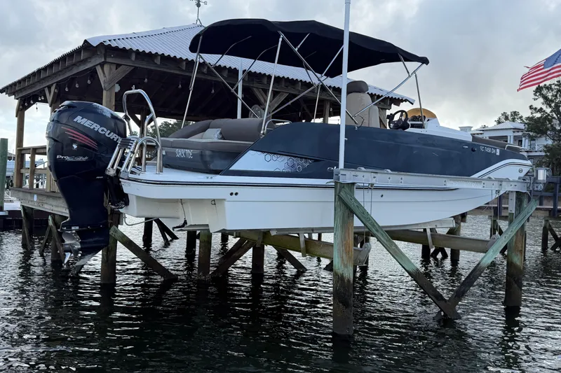 Slide: The Image of 2017 Bayliner Element XR7 boat on lift with Mercury outboard motor. - 1