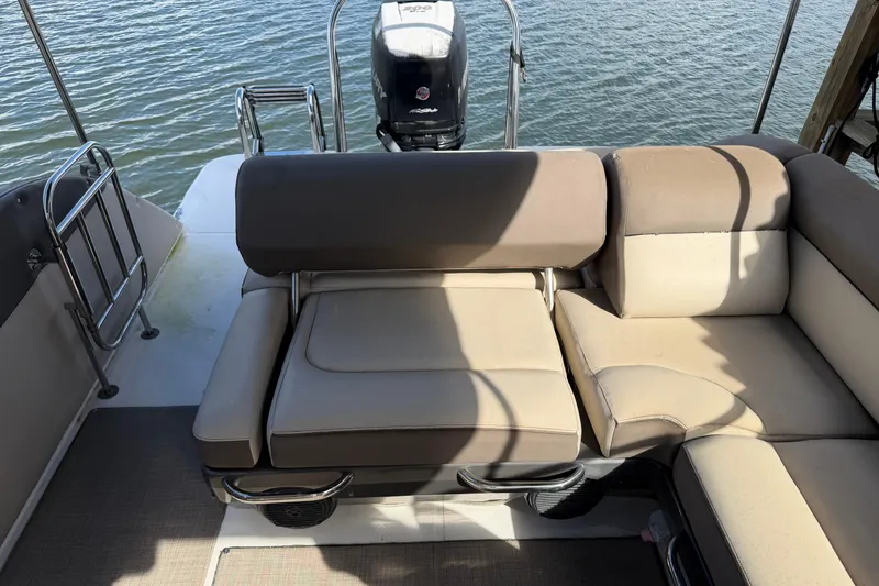 Slide: The Image of 2017 Bayliner Element XR7 boat interior with beige seating and outboard motor. - 11