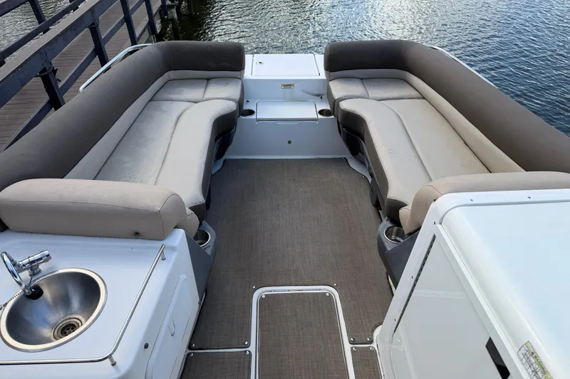 Slide: The Image of 2017 Bayliner Element XR7 boat interior with spacious seating and a built-in sink. - 5