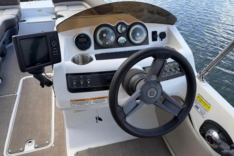 Slide: The Image of 2017 Bayliner Element XR7 boat dashboard with steering wheel and navigation system. - 7