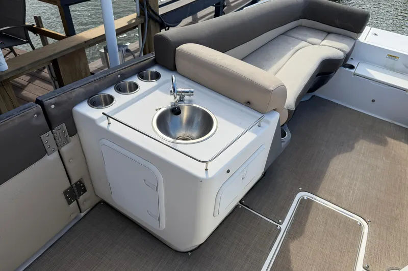 Slide: The Image of 2017 Bayliner Element XR7 boat interior with sink and seating area. - 8