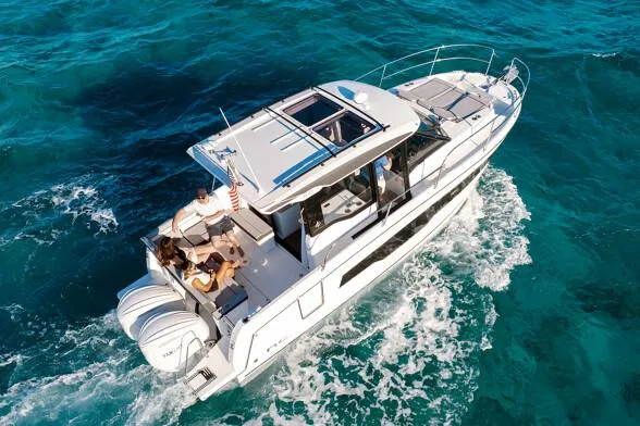 Slide: The Image of Manufacturer Provided Image: 2026 Jeanneau NC 895 Series 2 cruising on clear blue waters. - 3