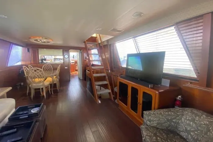 Slide: The Image of Luxurious 1990 Viking Motor Yacht interior with elegant wood finishes and modern amenities. - 11