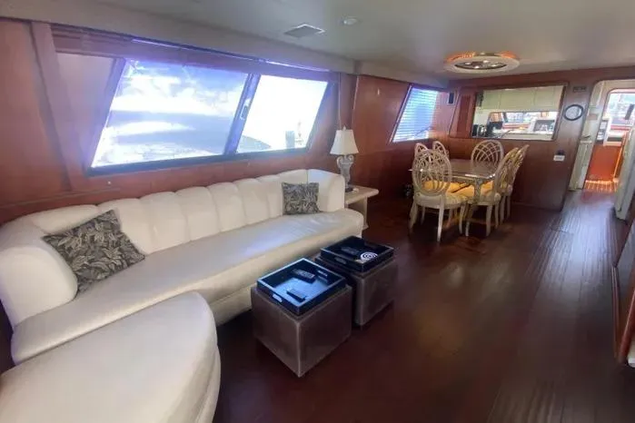 Slide: The Image of Luxurious interior of a 1990 Viking Motor Yacht with elegant seating and dining area. - 12
