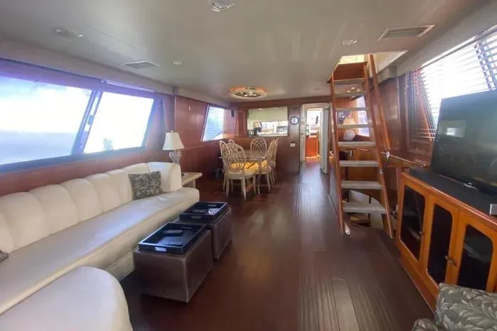 Slide: The Image of Luxurious interior of a 1990 Viking Motor Yacht with elegant seating and dining area. - 13
