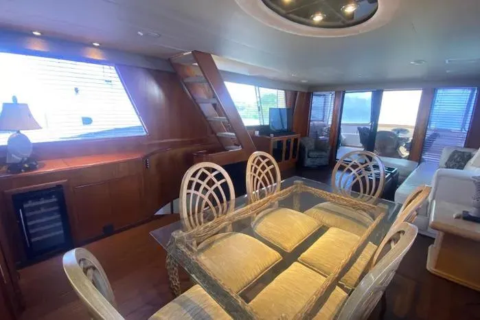 Slide: The Image of Luxurious interior of a 1990 Viking Motor Yacht with elegant dining area and seating. - 14