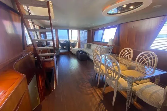 Slide: The Image of Luxurious interior of a 1990 Viking Motor Yacht with elegant dining area and wooden finishes. - 16