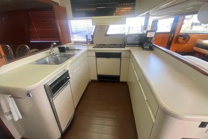 Slide: The Image of 1990 Viking Motor Yacht kitchen with modern appliances and sleek countertops. - 17