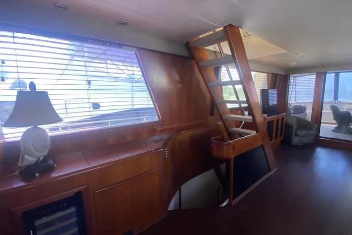 Slide: The Image of Interior of 1990 Viking Motor Yacht with wooden finishes and modern decor. - 19