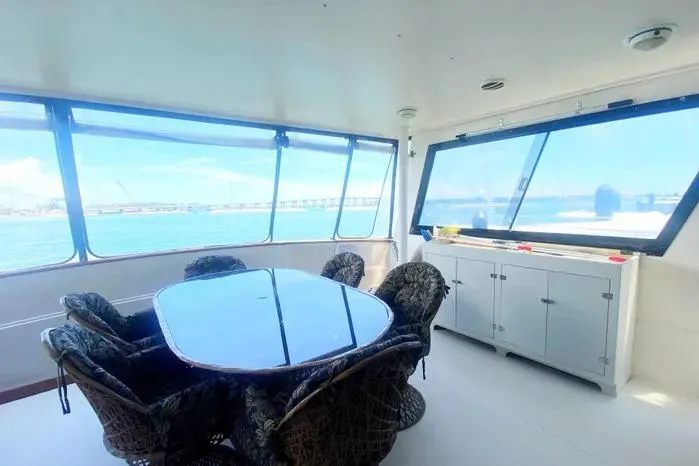 Slide: The Image of Luxurious 1990 Viking Motor Yacht interior with dining area and panoramic windows. - 2