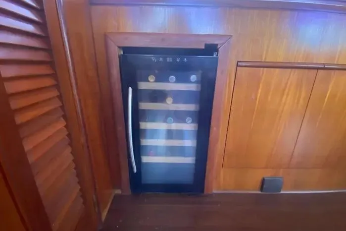 Slide: The Image of Built-in wine cooler on 1990 Viking Motor Yacht with wooden cabinetry. - 20