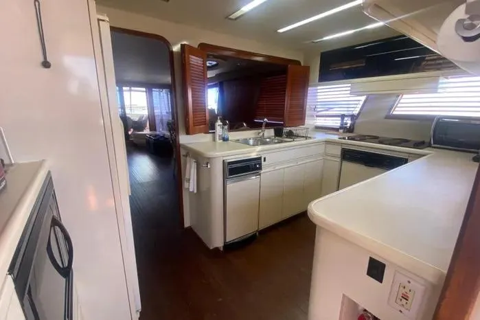 Slide: The Image of 1990 Viking Motor Yacht kitchen with modern appliances and wood accents. - 22