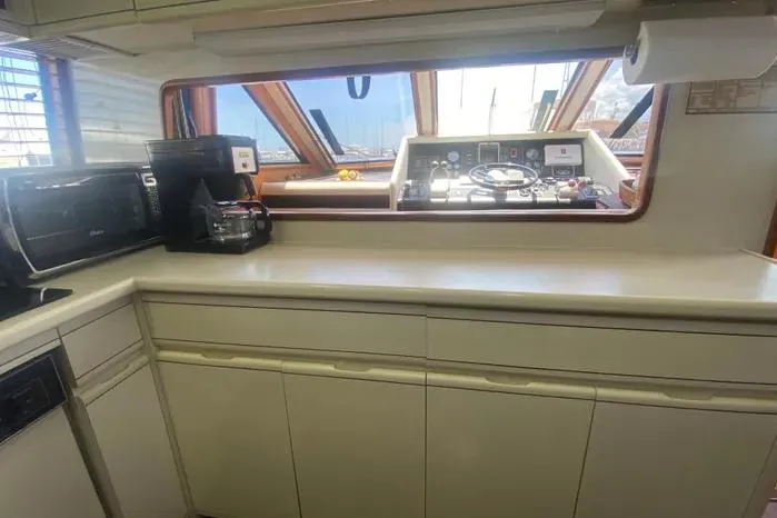 Slide: The Image of Interior of a 1990 Viking Motor Yacht with kitchen and helm view. - 24