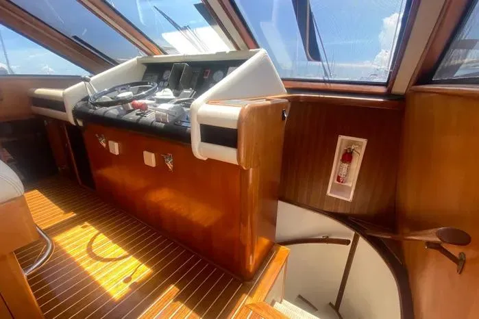 Slide: The Image of Interior helm of 1990 Viking Motor Yacht with wooden finish and navigation controls. - 29