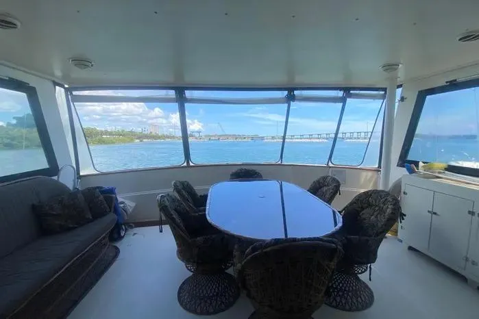 Slide: The Image of Interior of 1990 Viking Motor Yacht with ocean view and dining area. - 3