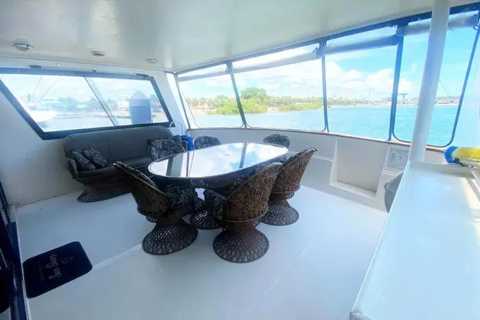 Slide: The Image of Spacious 1990 Viking Motor Yacht interior with elegant seating and panoramic windows. - 4