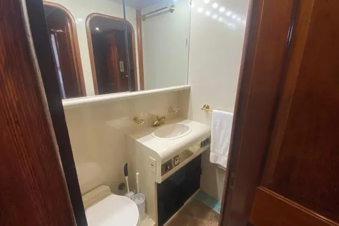 Slide: The Image of Bathroom interior of a 1990 Viking Motor Yacht with sink and mirror. - 40