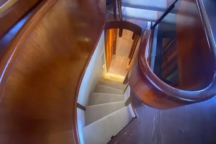 Slide: The Image of Curved wooden staircase inside 1990 Viking Motor Yacht, leading to lower deck. - 41