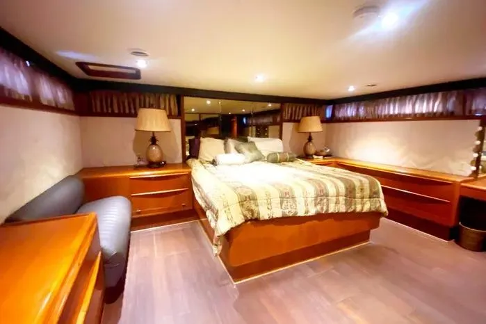 Slide: The Image of Luxurious bedroom interior of a 1990 Viking Motor Yacht with elegant wood furnishings. - 45