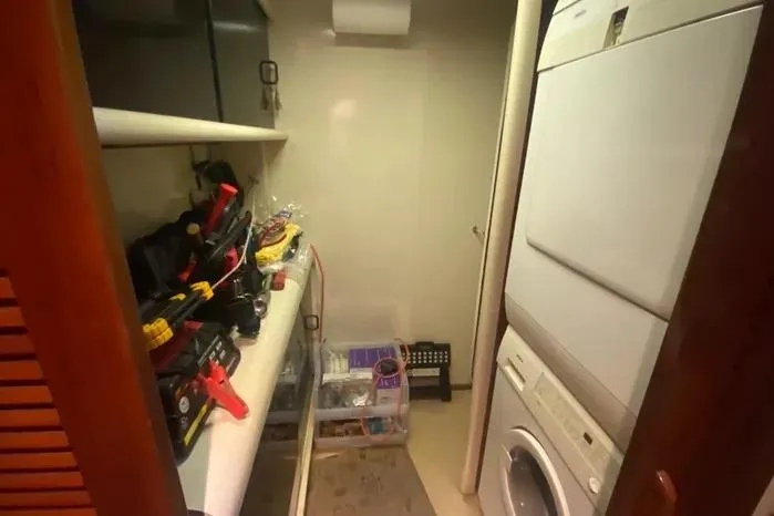 Slide: The Image of Laundry room on a 1990 Viking Motor Yacht with stacked washer and dryer. - 47