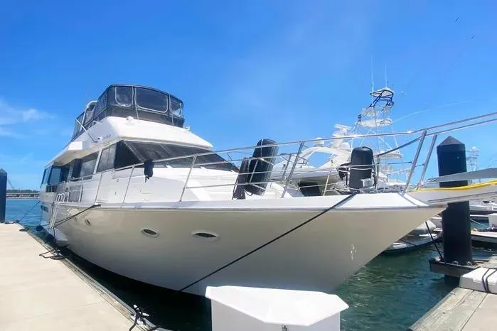 Slide: The Image of 1990 Viking Motor Yacht docked under clear blue sky. - 5