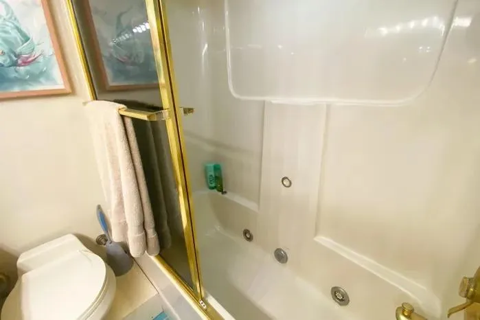 Slide: The Image of Bathroom interior of 1990 Viking Motor Yacht with shower and toilet. - 54