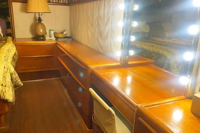 Slide: The Image of Luxurious 1990 Viking motor yacht interior with wooden vanity and illuminated mirror. - 59