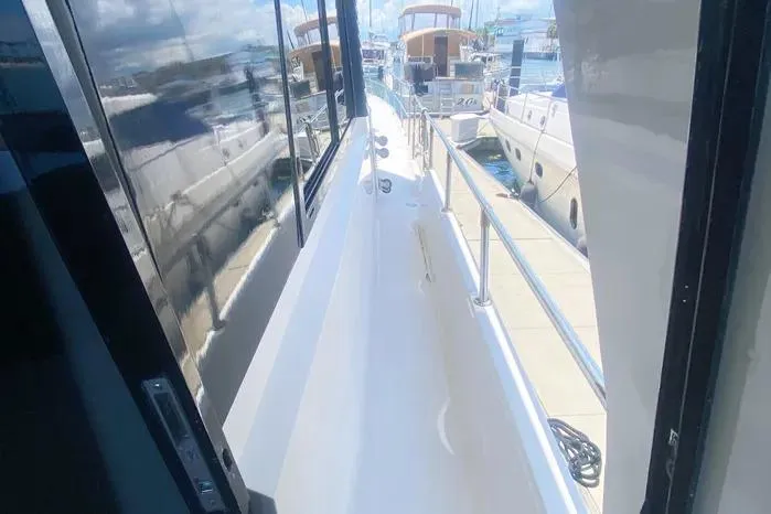 Slide: The Image of 1990 Viking Motor Yacht deck view with marina background. - 6