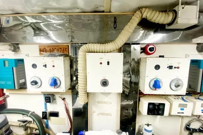 Slide: The Image of Engine room of a 1990 Viking Motor Yacht with control panels and ventilation system. - 66