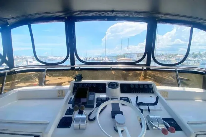 Slide: The Image of Cockpit view of a 1990 Viking Motor Yacht with marina in the background. - 71