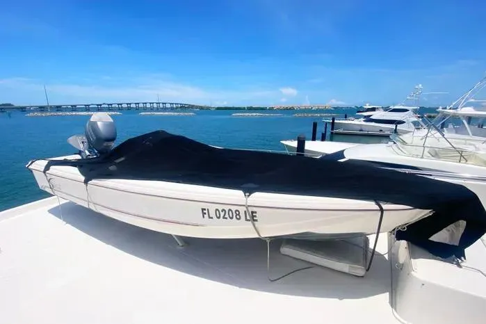 Slide: The Image of Covered Viking motor yacht from 1990 docked by the sea with a scenic bridge view. - 74