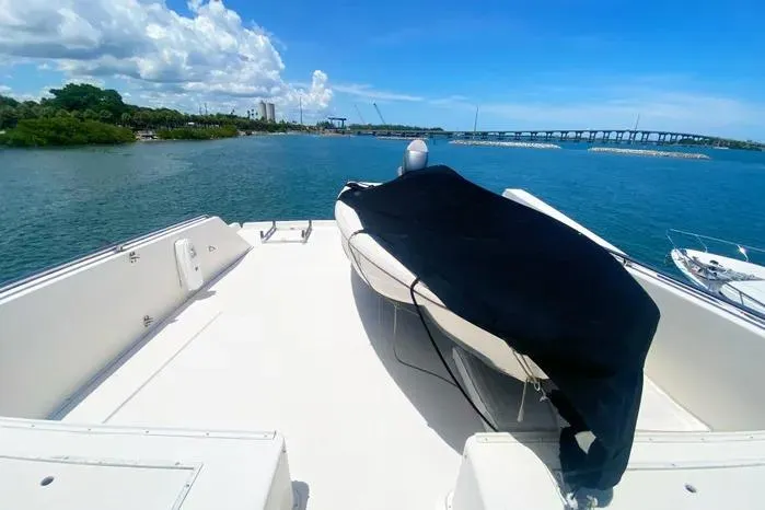 Slide: The Image of 1990 Viking Motor Yacht deck with covered equipment, overlooking scenic waterway and bridge. - 75