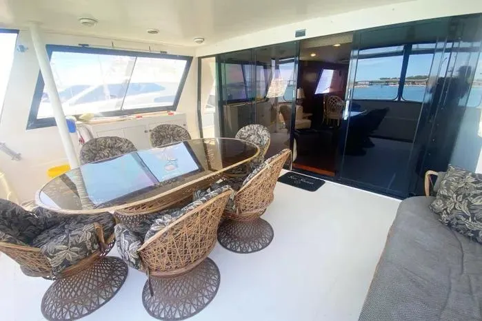 Slide: The Image of Spacious 1990 Viking Motor Yacht interior with elegant dining area and comfortable seating. - 8